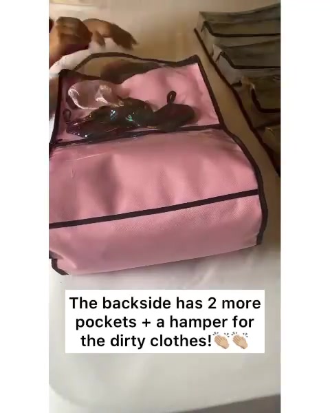 Back of a pink SuitcaseMate showing two pockets and its hamper for dirty clothes