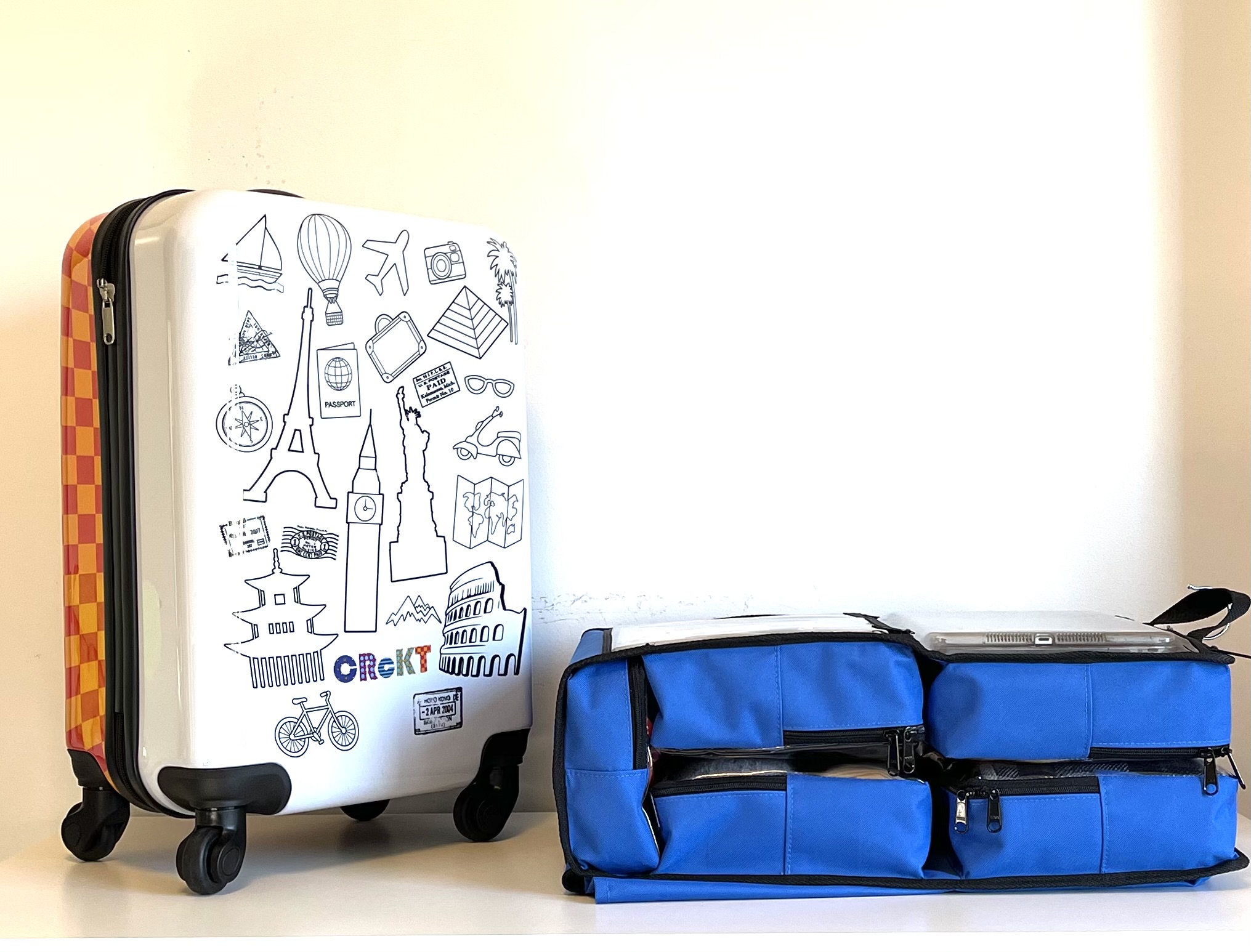 Blue SuitcaseMate folded beside a child's rolling suitcase